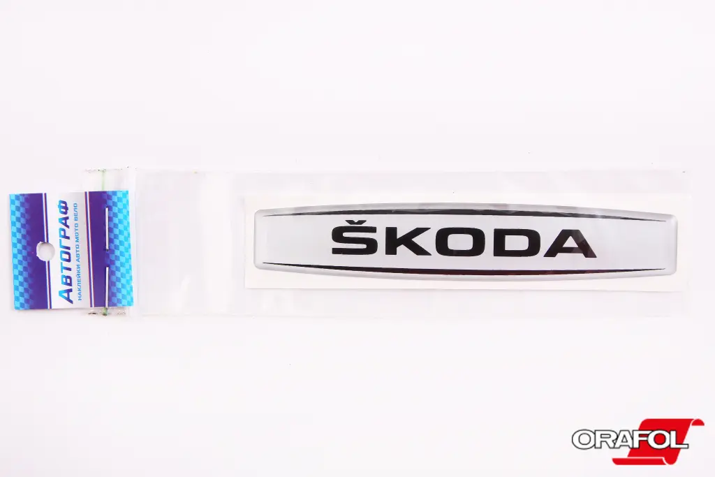 наклейка Эмблема силикон Skoda серебр. фон, черная 2*12см 